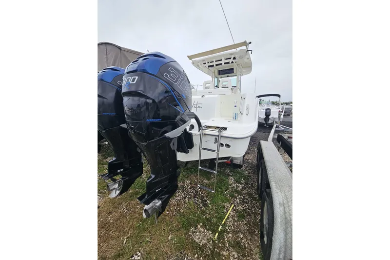  Yacht Photos Pics 2013 Boston Whaler 320 Outrage with dual Mercury engines, docked on a trailer.