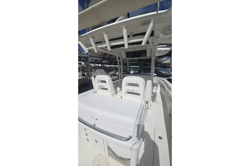  Yacht Photos Pics 2013 Boston Whaler 320 Outrage boat interior with seating and storage.