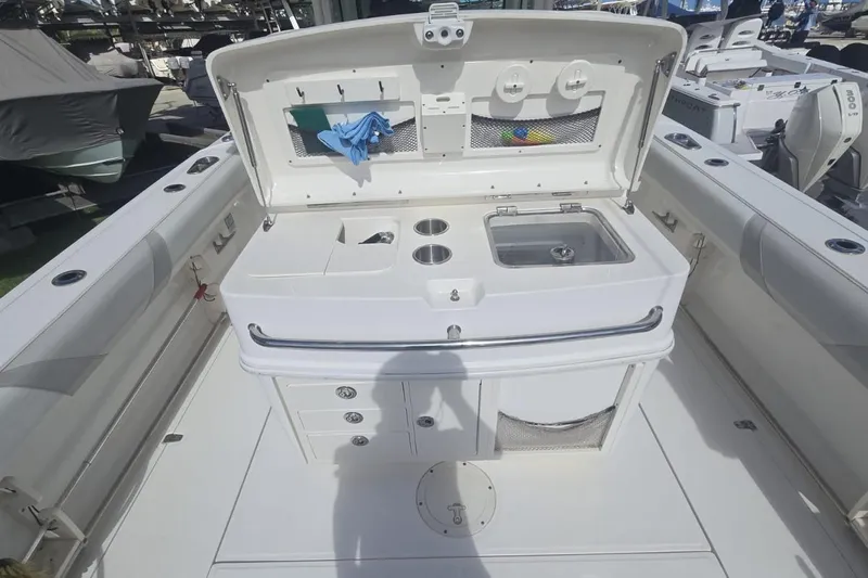  Yacht Photos Pics 2013 Boston Whaler 320 Outrage boat interior with sink and storage compartments.