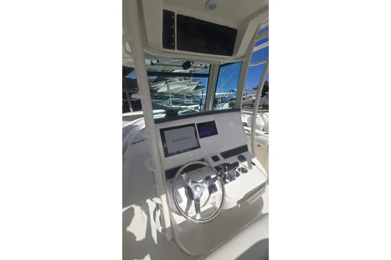  Yacht Photos Pics 2013 Boston Whaler 320 Outrage helm with Garmin navigation system and steering wheel.