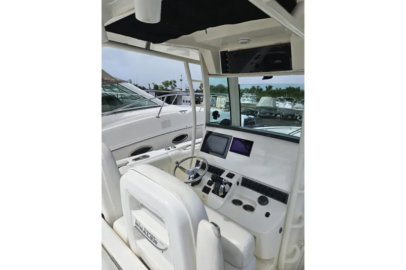  Yacht Photos Pics 2013 Boston Whaler 320 Outrage boat cockpit with modern controls and steering wheel.