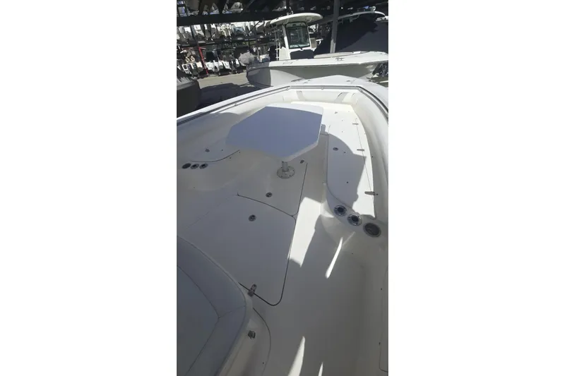  Yacht Photos Pics 2013 Boston Whaler 320 Outrage boat interior with seating and table.