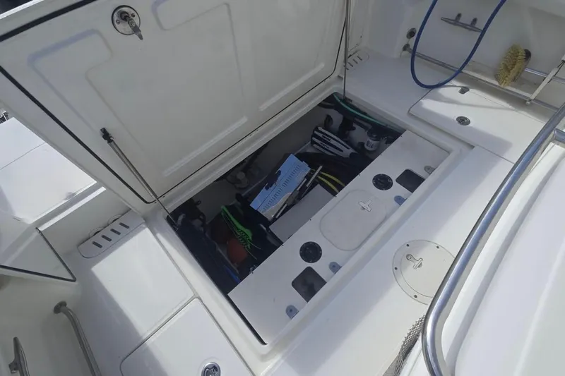  Yacht Photos Pics Open storage compartment on 2013 Boston Whaler 320 Outrage boat, showing equipment and gear.