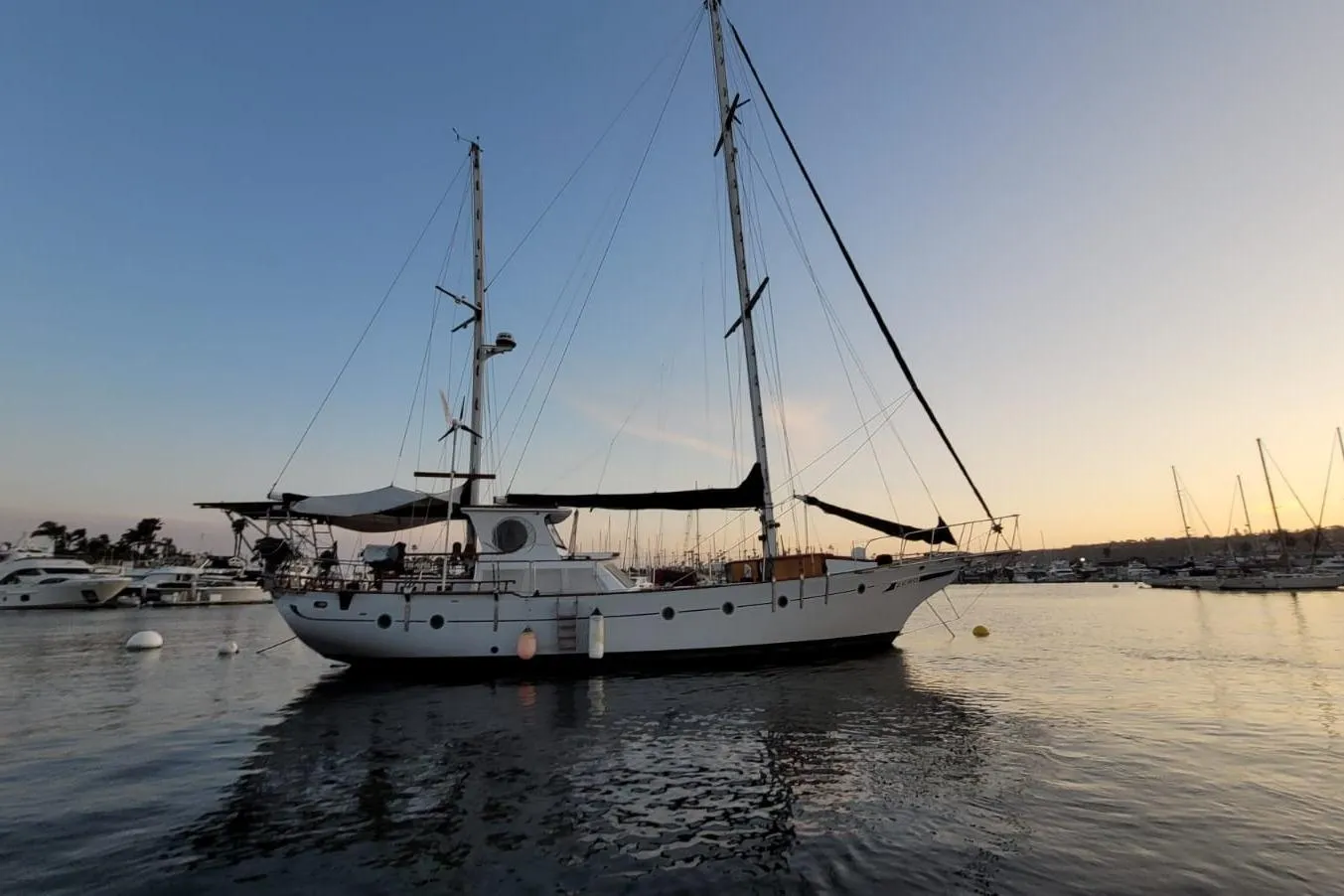 1974 Force Hudson 50 sailboat docked at sunset in a serene marina.