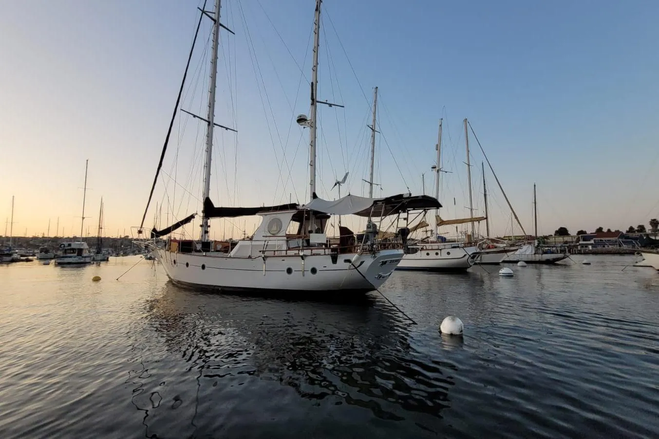 Sailboats docked at sunset, featuring a 1974 Force Hudson 50.