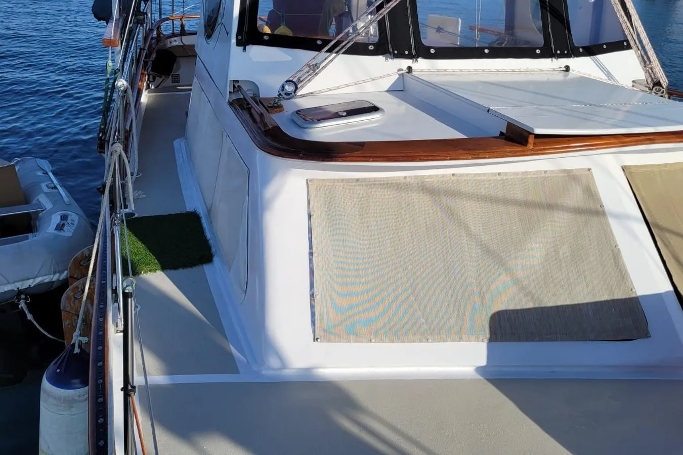 1974 Force Hudson 50 yacht deck with sunshade, docked by the water.