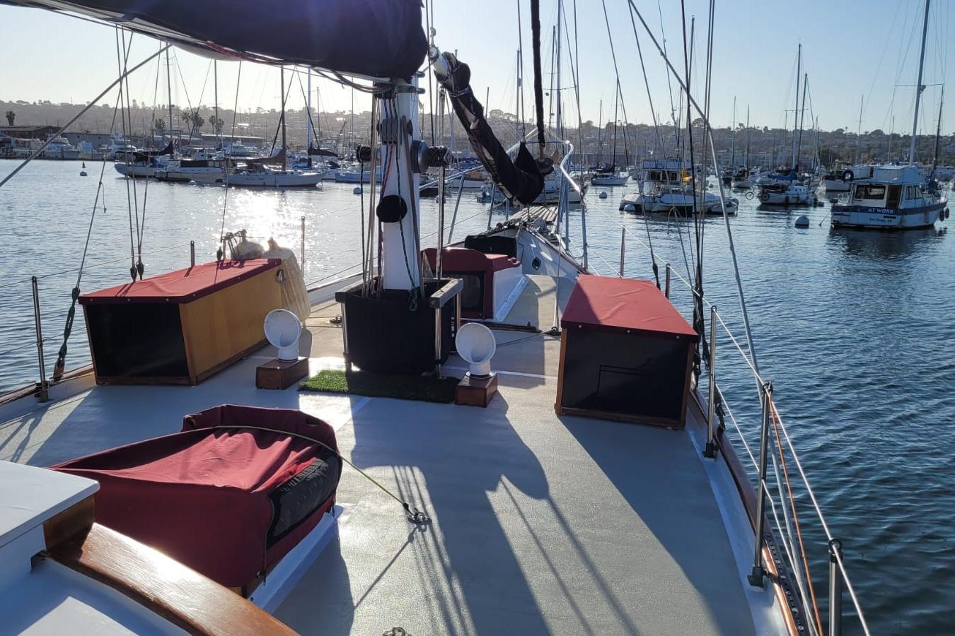 1974 Force Hudson 50 sailboat docked in a marina, surrounded by other boats.
