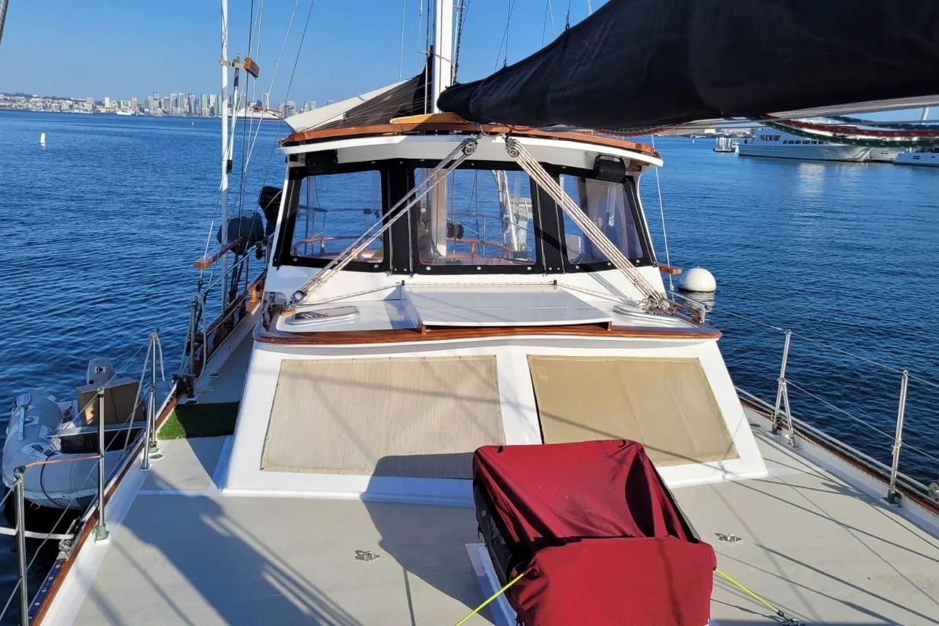 1974 Force Hudson 50 sailboat on calm water with city skyline in background.