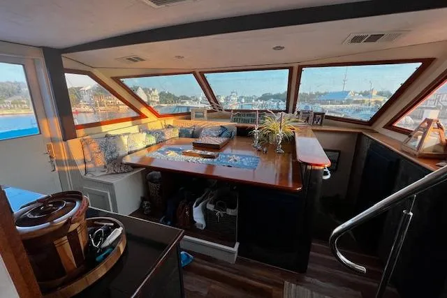  Yacht Photos Pics 1989 Hatteras 70 Cockpit Motor Yacht interior with panoramic windows and elegant seating area.