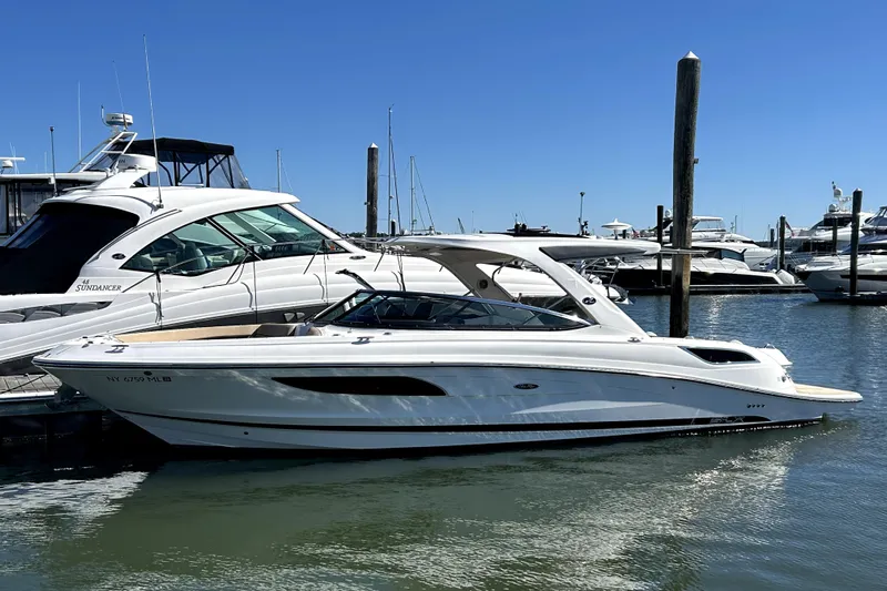  Yacht Photos Pics 2016 Sea Ray 350 SLX boat docked in marina under clear blue sky.