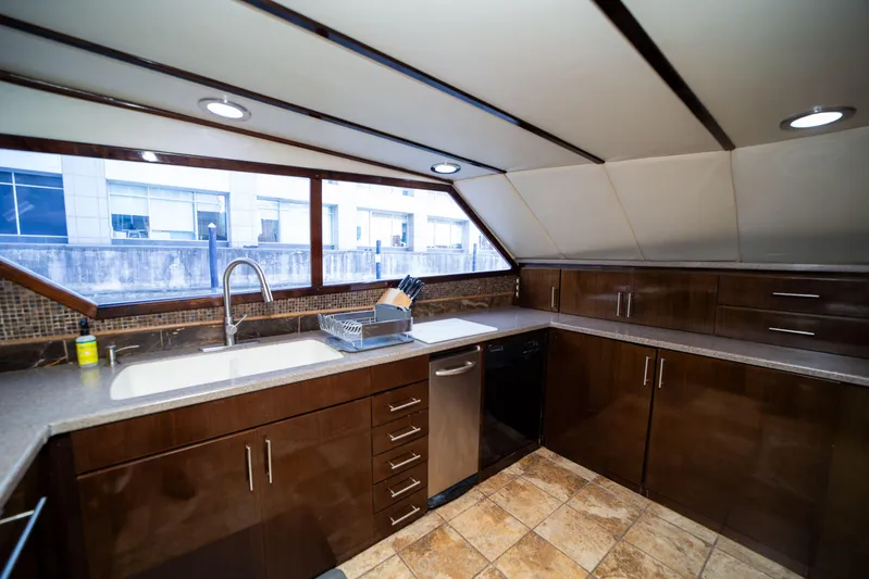 Justine Yacht Photos Pics Luxurious kitchen interior on a 1987 Guy Couach 97 yacht, featuring modern cabinetry and ample counter space.