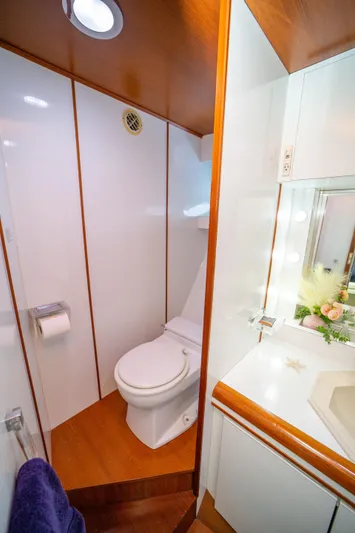 Justine Yacht Photos Pics Luxurious bathroom in 1987 Guy Couach 97 yacht with modern fixtures and wooden accents.