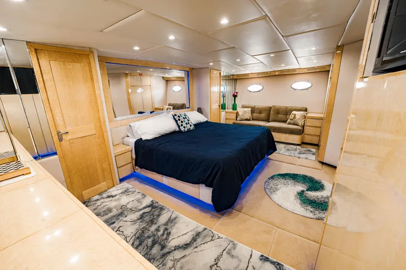 Justine Yacht Photos Pics Luxurious bedroom interior on 1987 Guy Couach 97 yacht with modern decor and ambient lighting.