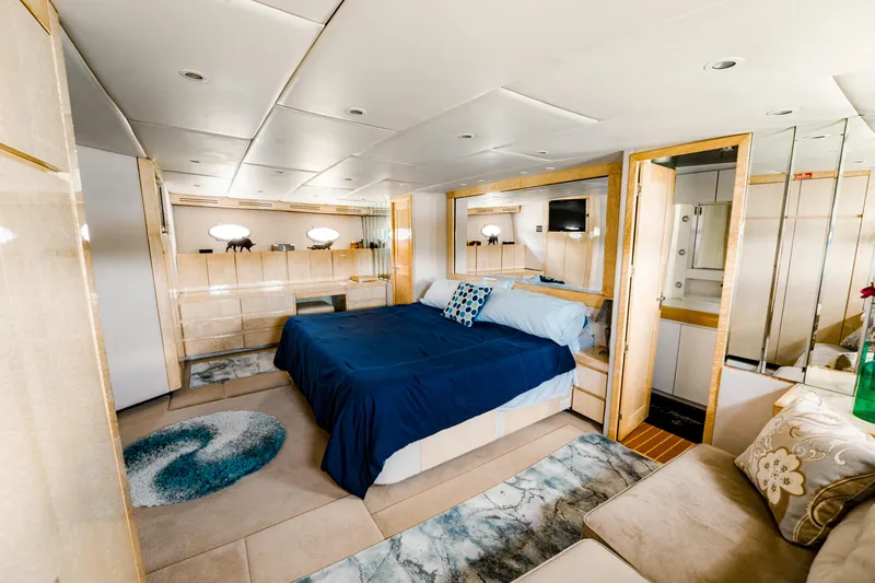 Justine Yacht Photos Pics Luxurious bedroom interior of 1987 Guy Couach 97 yacht with modern decor and cozy bedding.