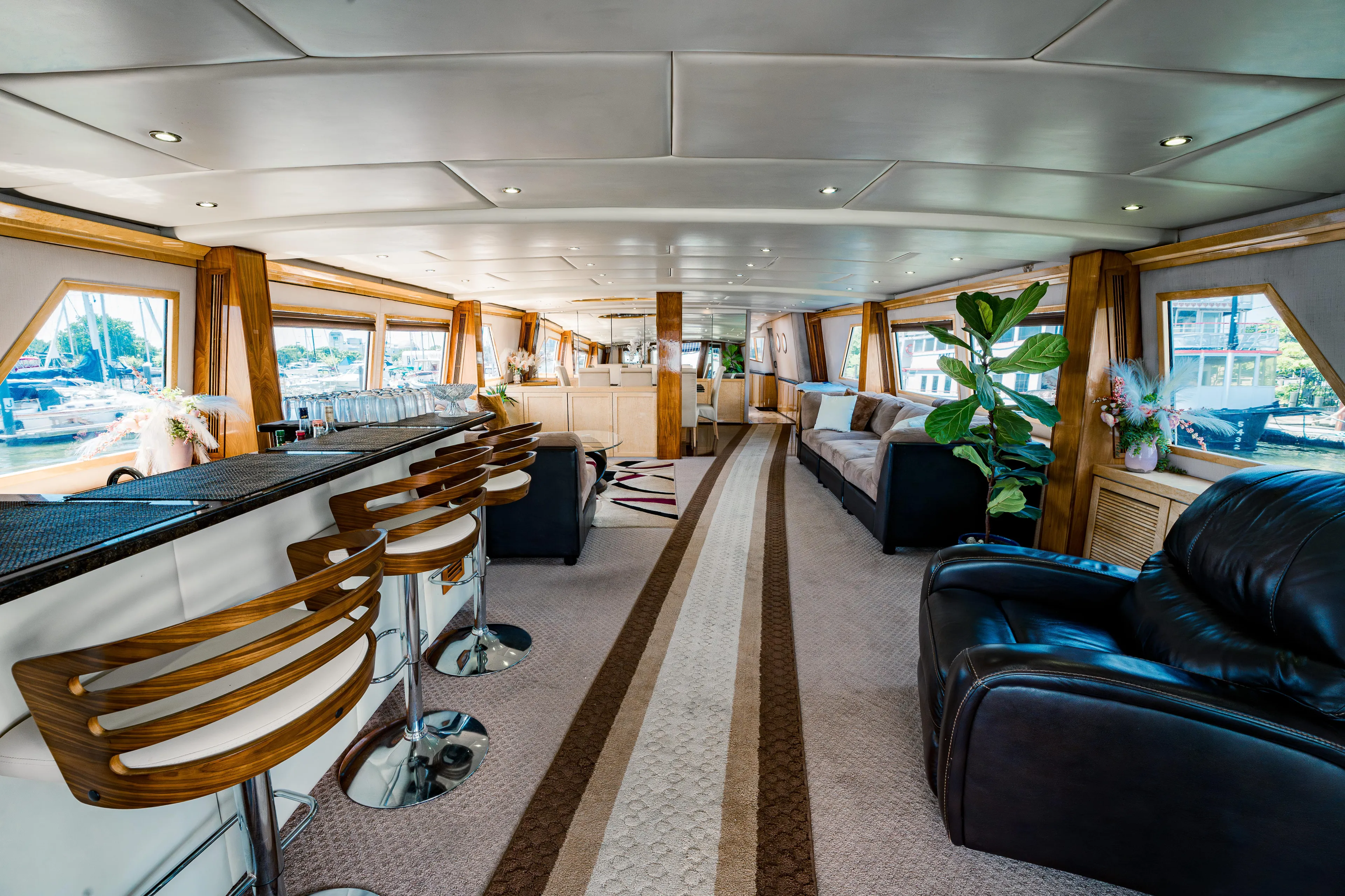 Justine Yacht Photos Pics Luxurious interior of a 1987 Guy Couach 97 yacht with modern seating and elegant decor.
