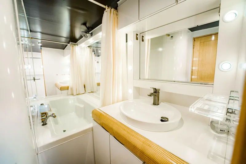 Justine Yacht Photos Pics Luxurious bathroom in 1987 Guy Couach 97 yacht with modern fixtures and elegant design.