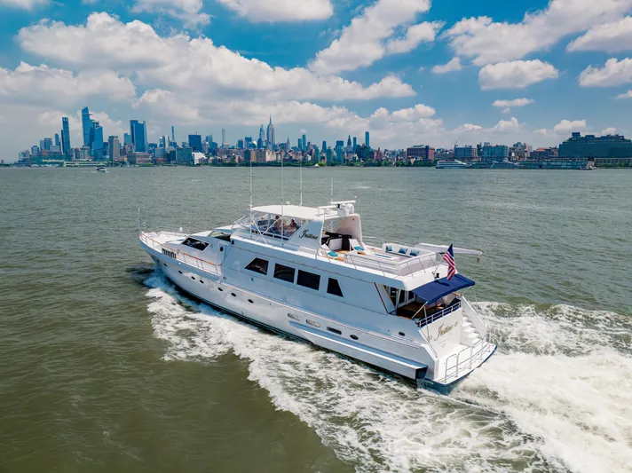 Justine Yacht Photos Pics Luxury yacht Guy Couach 97 cruising near city skyline, 1987 model.
