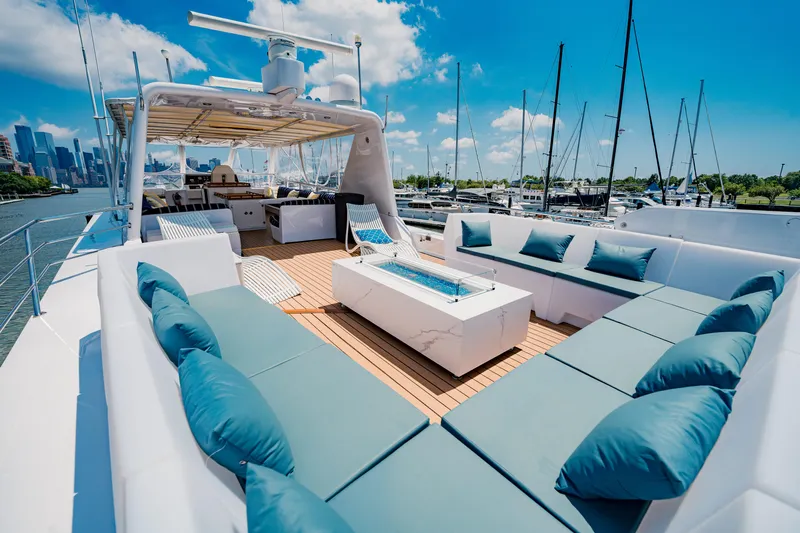 Justine Yacht Photos Pics Luxurious 1987 Guy Couach 97 yacht with spacious deck and elegant seating.