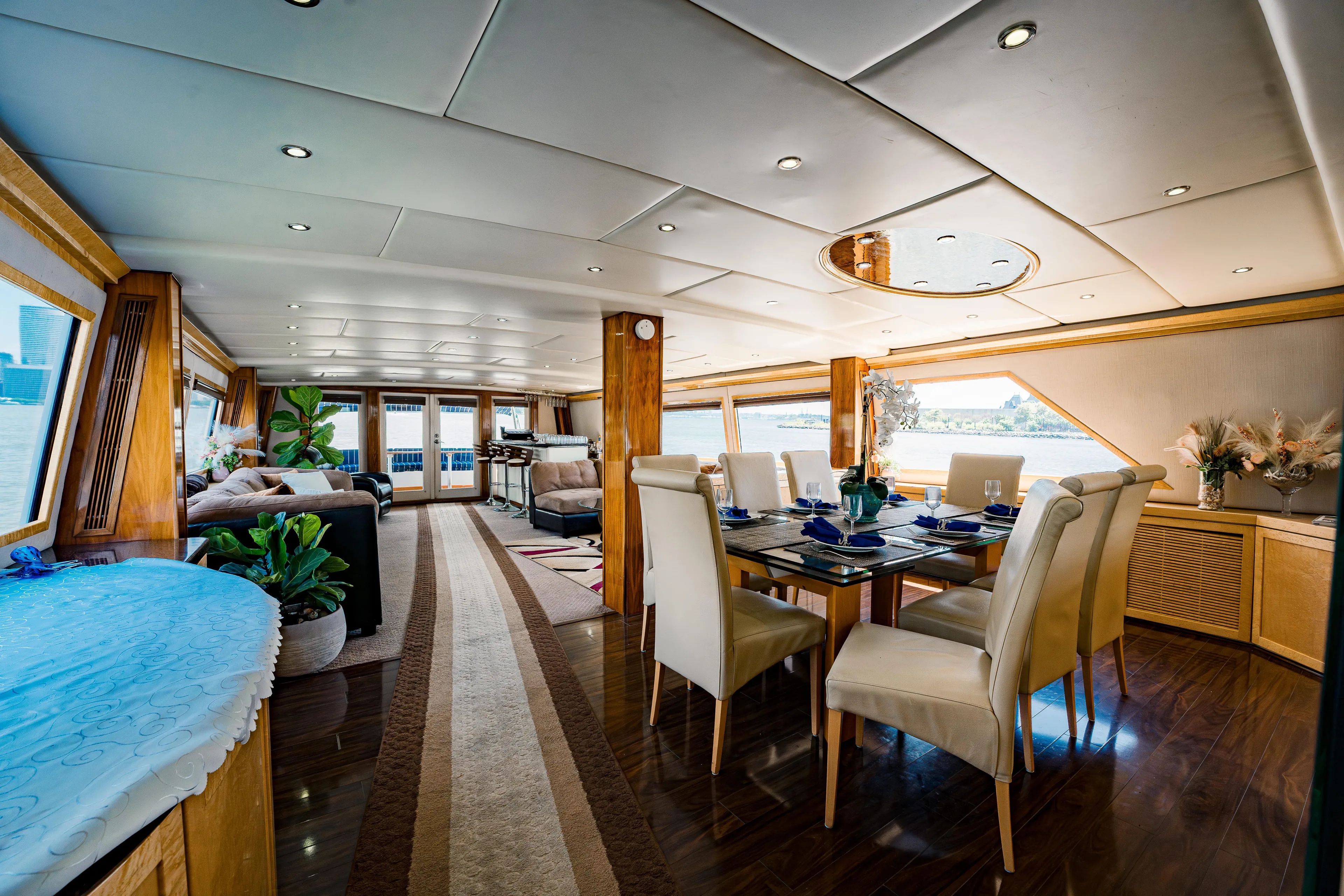 Justine Yacht Photos Pics Luxurious interior of 1987 Guy Couach 97 yacht with elegant dining area and panoramic windows.