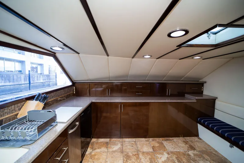 Justine Yacht Photos Pics Luxurious kitchen interior of 1987 Guy Couach 97 yacht with modern amenities and sleek design.