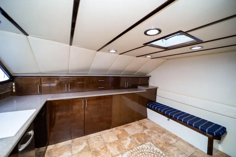 Justine Yacht Photos Pics Luxurious interior of 1987 Guy Couach 97 yacht with modern cabinetry and seating.