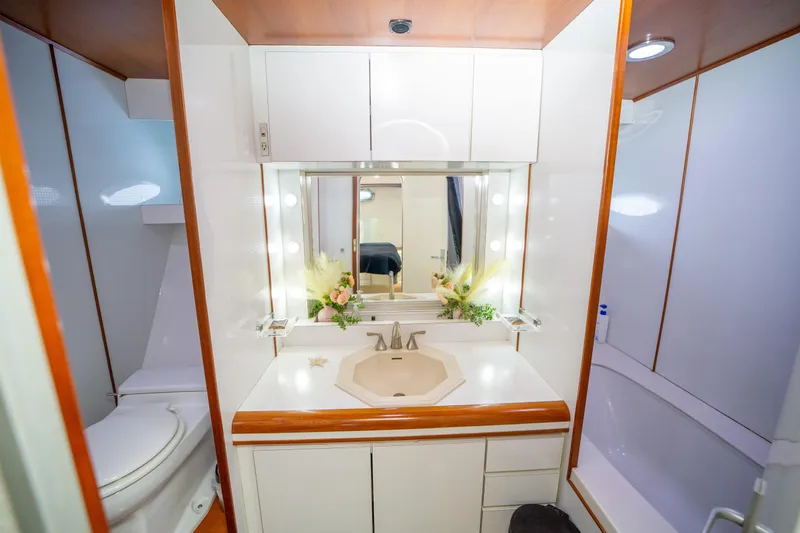 Justine Yacht Photos Pics Luxurious bathroom on 1987 Guy Couach 97 yacht with elegant fixtures and floral decor.