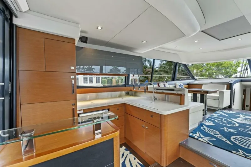 Never Enough Yacht Photos Pics Interior of 2013 Prestige 550 Flybridge yacht with modern kitchen and seating area.