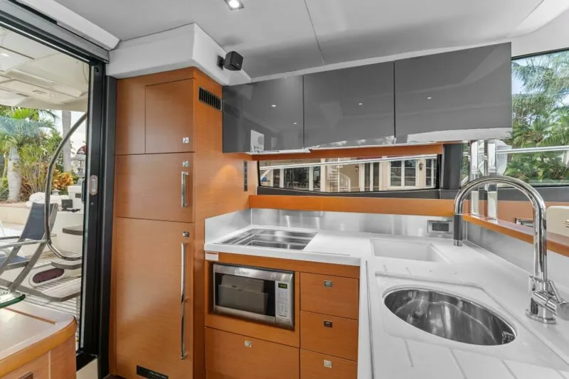 Never Enough Yacht Photos Pics Modern kitchen interior on 2013 Prestige 550 Flybridge yacht, featuring sleek cabinetry and appliances.