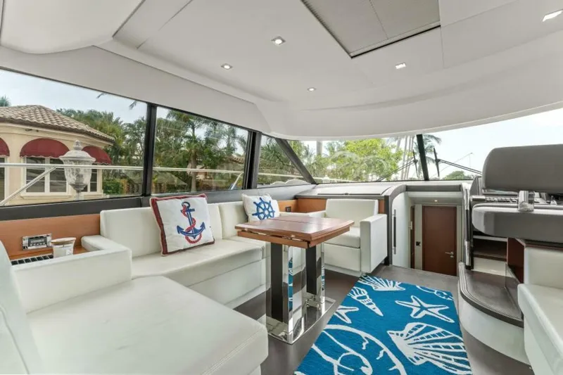 Never Enough Yacht Photos Pics Luxurious interior of 2013 Prestige 550 Flybridge yacht with modern seating and nautical decor.