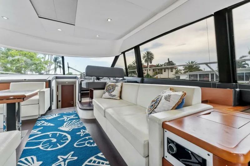Never Enough Yacht Photos Pics Luxurious interior of 2013 Prestige 550 Flybridge yacht with elegant seating and nautical decor.