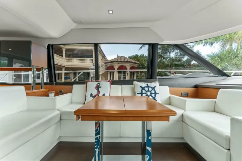 Never Enough Yacht Photos Pics Luxurious interior of 2013 Prestige 550 Flybridge yacht with elegant seating and nautical decor.