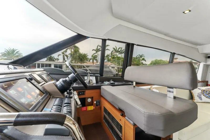 Never Enough Yacht Photos Pics Interior of 2013 Prestige 550 Flybridge yacht with modern helm and seating.