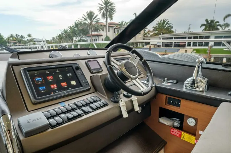 Never Enough Yacht Photos Pics Helm of 2013 Prestige 550 Flybridge yacht with modern controls and navigation system.