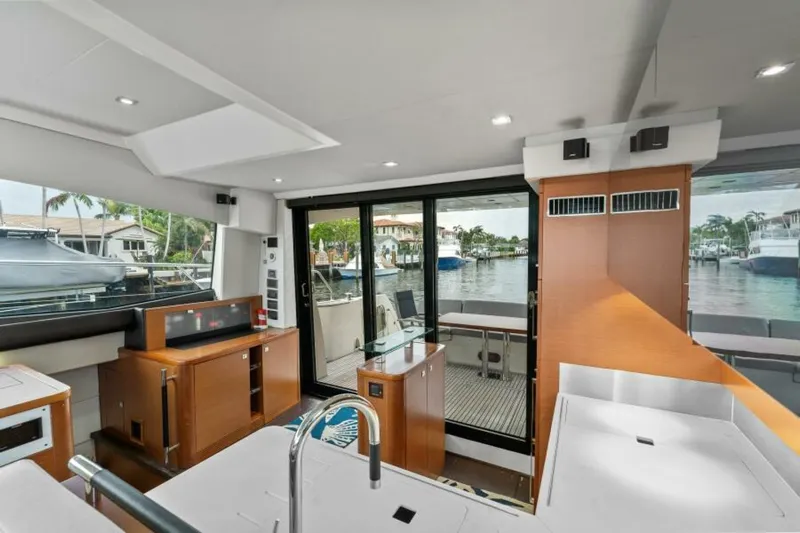 Never Enough Yacht Photos Pics Interior of 2013 Prestige 550 Flybridge yacht with modern kitchen and waterfront view.