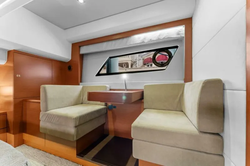 Never Enough Yacht Photos Pics Interior of 2013 Prestige 550 Flybridge yacht with seating and window view.