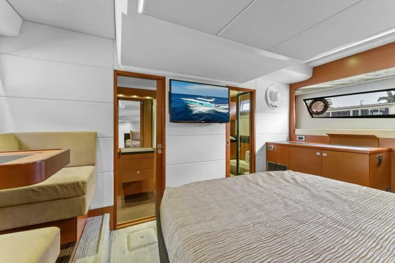 Never Enough Yacht Photos Pics Luxurious interior of 2013 Prestige 550 Flybridge yacht bedroom with modern decor.