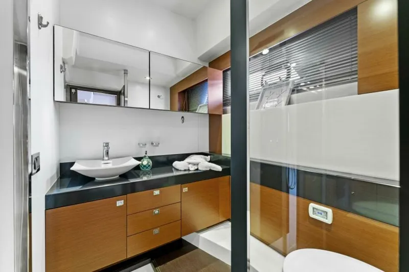 Never Enough Yacht Photos Pics Luxurious bathroom in 2013 Prestige 550 Flybridge yacht with modern fixtures and wood accents.