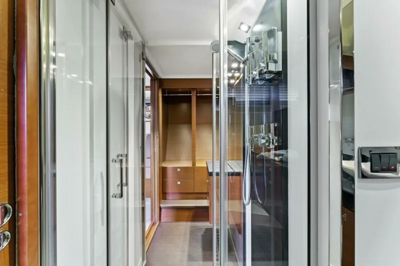 Never Enough Yacht Photos Pics Interior of 2013 Prestige 550 Flybridge yacht, featuring modern shower and wooden cabinetry.