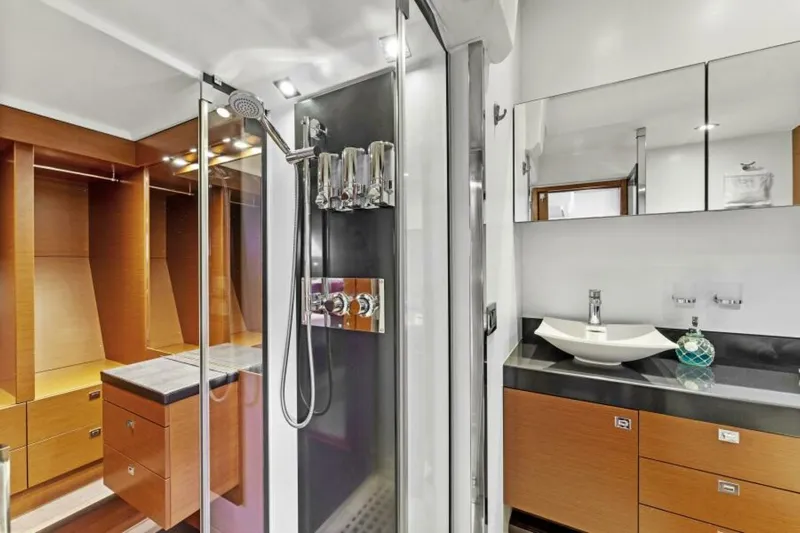 Never Enough Yacht Photos Pics Luxurious bathroom on 2013 Prestige 550 Flybridge yacht with modern fixtures and wooden cabinetry.