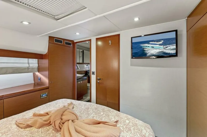 Never Enough Yacht Photos Pics Luxurious cabin interior of 2013 Prestige 550 Flybridge yacht with TV and elegant decor.