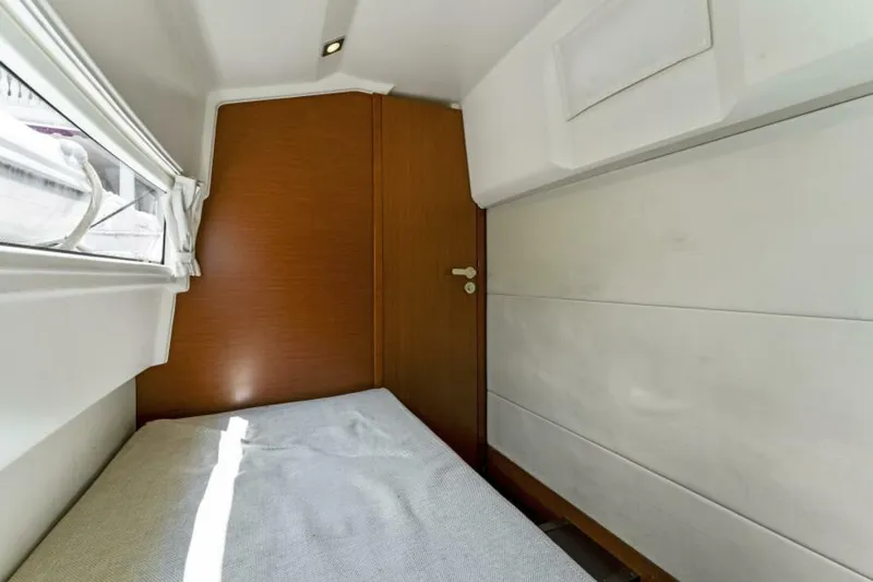 Never Enough Yacht Photos Pics Small cabin interior of 2013 Prestige 550 Flybridge yacht with bed and window.