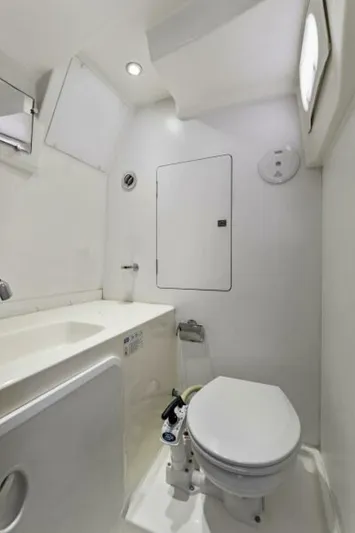 Never Enough Yacht Photos Pics Bathroom interior of 2013 Prestige 550 Flybridge yacht, featuring modern fixtures and white decor.