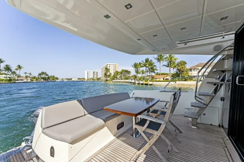 Never Enough Yacht Photos Pics Prestige 550 Flybridge 2013 yacht deck with seating, table, and ocean view.