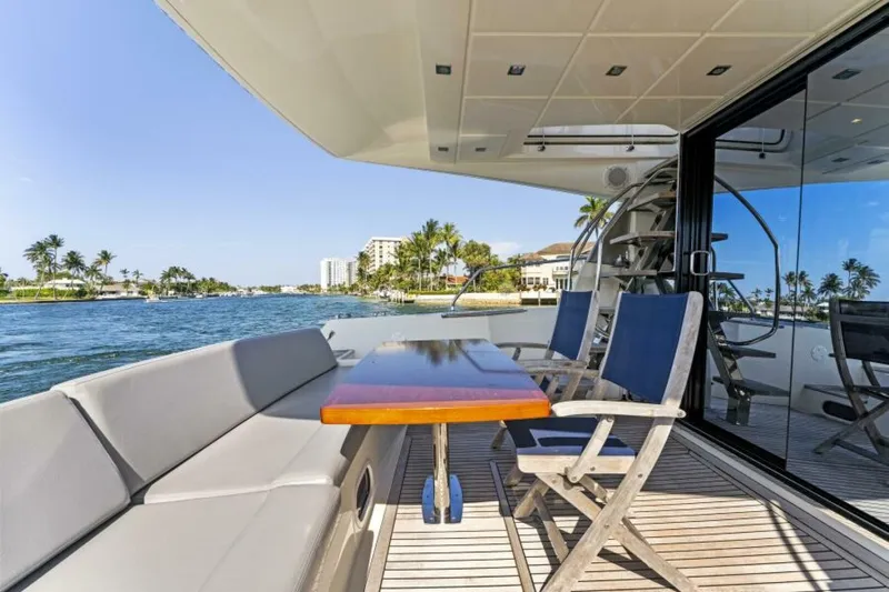 Never Enough Yacht Photos Pics Prestige 550 Flybridge 2013 yacht deck with seating and ocean view.