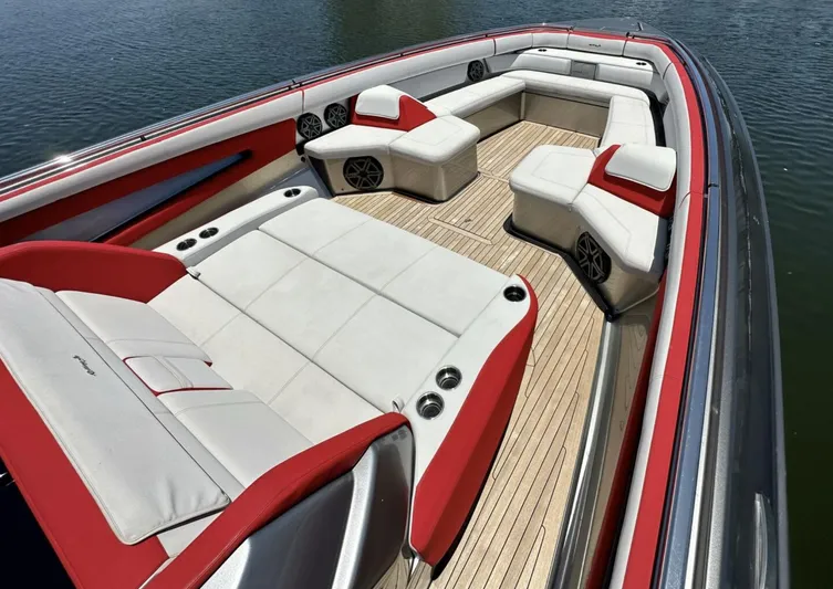  Yacht Photos Pics 2020 Cigarette 59 Tirranna boat interior with red and white seating, wooden deck.
