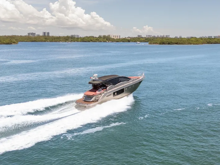  Yacht Photos Pics 2023 Cranchi M44HT yacht cruising on a sunny day, surrounded by blue water.