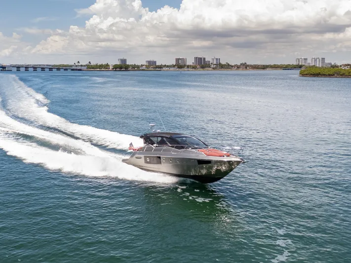  Yacht Photos Pics 2023 Cranchi M44HT yacht cruising on open water under a cloudy sky.