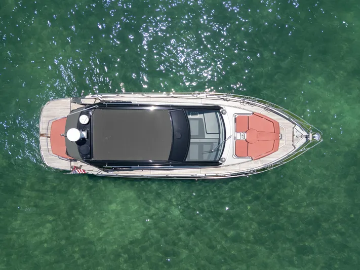  Yacht Photos Pics Aerial view of 2023 Cranchi M44HT yacht on clear green water.