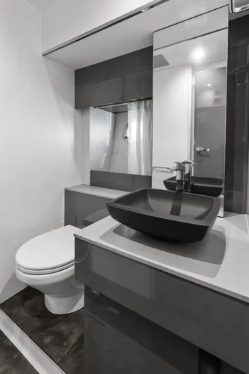  Yacht Photos Pics Modern bathroom in 2023 Cranchi M44HT yacht with sleek black sink and mirror.