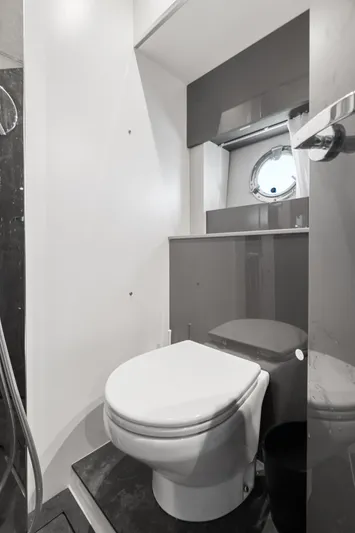  Yacht Photos Pics Modern bathroom in 2023 Cranchi M44HT yacht with sleek design and porthole window.